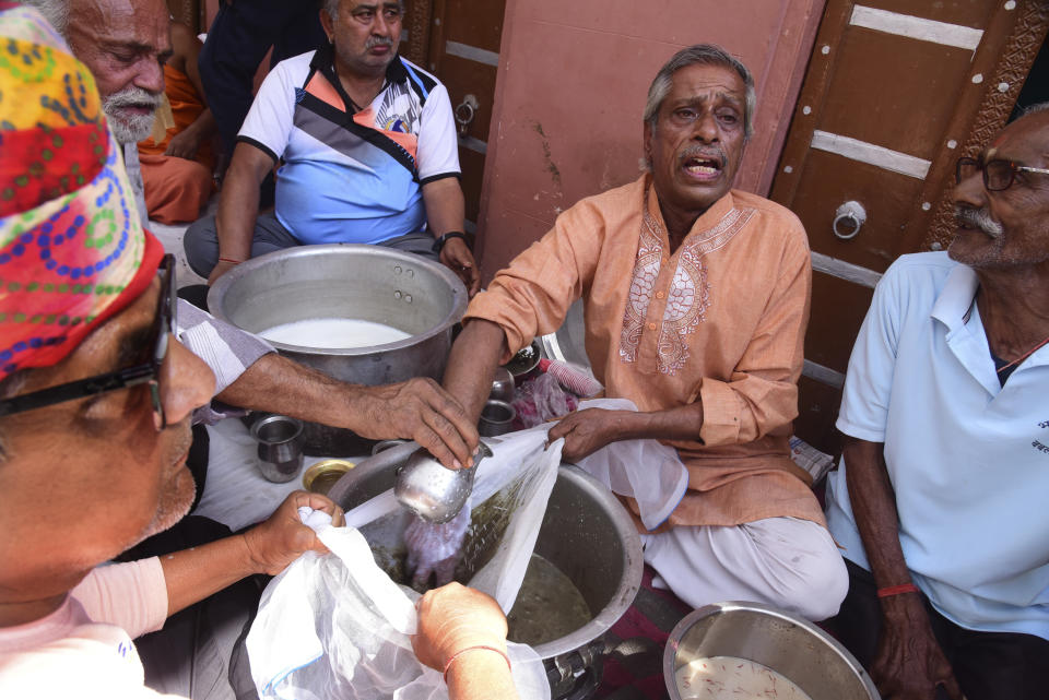 People prepare Bhang, a beverage prepared with milk, dry fruits and cannabis, during Holi festivities in Bikaner, in the Indian state of Rajasthan, India, Thursday, March 21, 2024. Holi, the Hindu festival of colors that also heralds the coming of spring, is being celebrated across the country Monday. Bhang is a popular drink during Holi. (AP Photo/Dinesh Gupta)