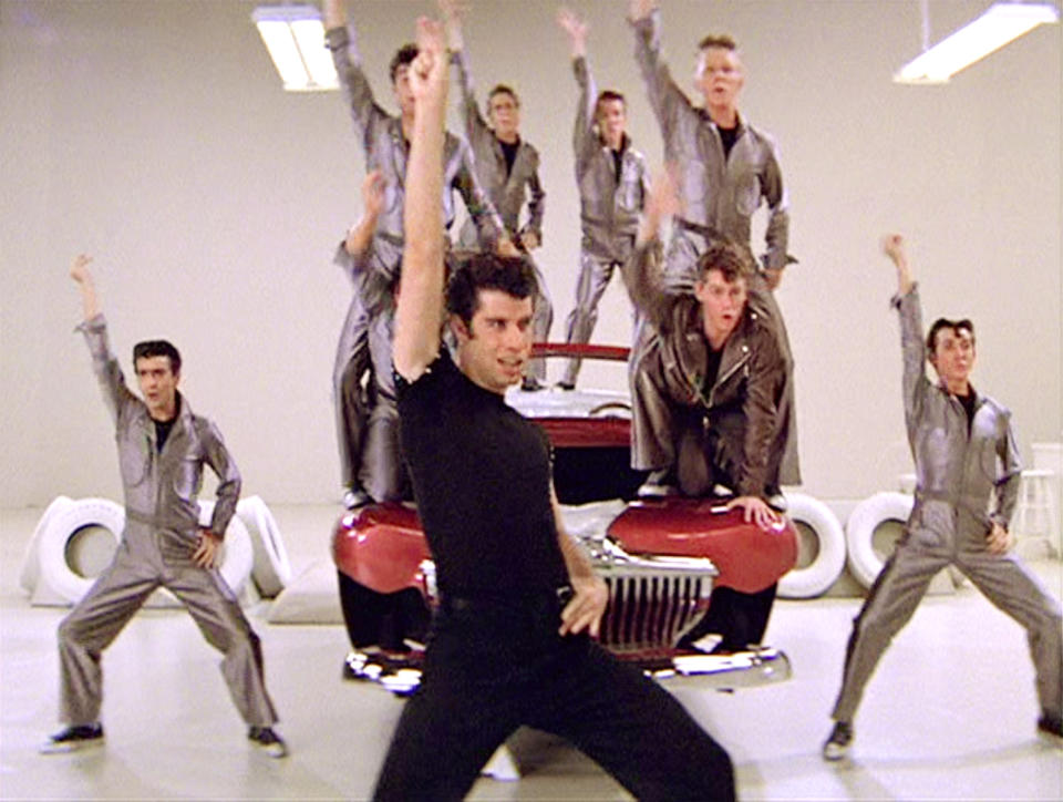 LOS ANGELES - JUNE 16: The movie "Grease", directed by Randal Kleiser. Seen here, the musical number,  "Greased Lightning," led by John Travolta (front and center) as Danny Zuko. Initial theatrical release of the film, June 16, 1978. Screen capture. Paramount Pictures. (Photo by CBS via Getty Images)