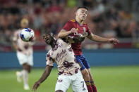 Portland Timbers' Franck Boli (7) and Real Salt Lake midfielder Braian Ojeda, right, vie for the ball during the first half of an MLS soccer match Wednesday, May 17, 2023, in Sandy, Utah. (AP Photo/Rick Bowmer)