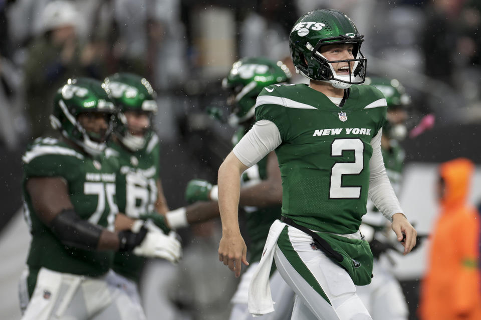 New York Jets quarterback Zach Wilson (2) reacts after wide receiver Randall Cobb (18) scored a touchdown against the Houston Texans during the second half of an NFL football game, Sunday, Dec. 10, 2023, in East Rutherford, N.J. (AP Photo/Adam Hunger)