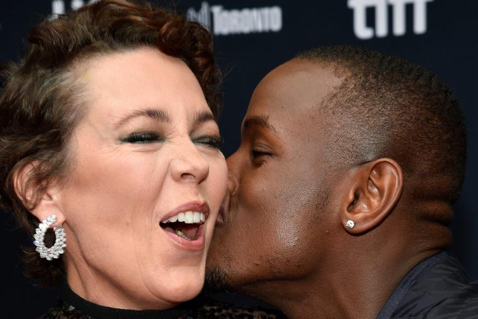 Actor Olivia Colman, left, gets a kiss from co-star Micheal Ward at the premiere of Empire of Light at the Toronto International Film Festival (Evan Agostini/Invision/AP)