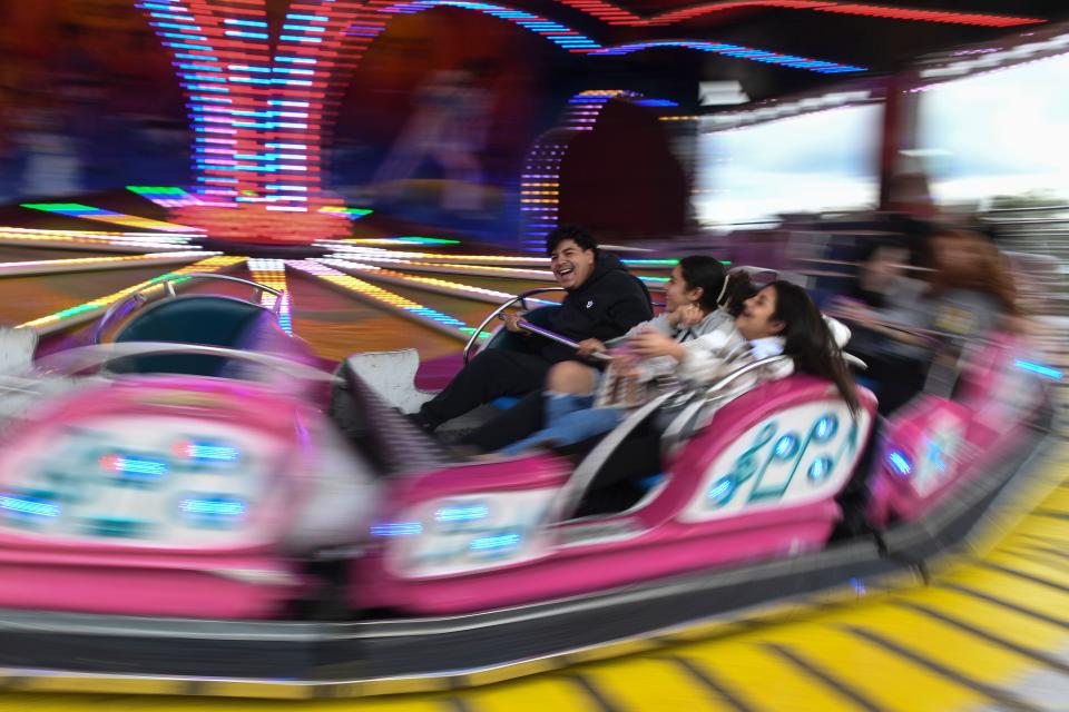 Fernando Martinez (left), Karlenne Gonzalez (center), and Cintha Gomez (left) ride ÒMusic ExpressÓ at the 100th Georgia-Carolina State Fair on Monday, Oct. 16, 2023. The fair will run through October 22nd.