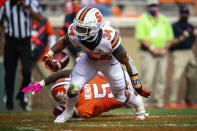 Syracuse running back Sean Tucker (34) gets past Clemson defensive end K.J. Henry (5) for a touchdown during an NCAA college football game in Clemson, S.C., on Saturday, Oct. 24, 2020. (Ken Ruinard/Pool Photo via AP)