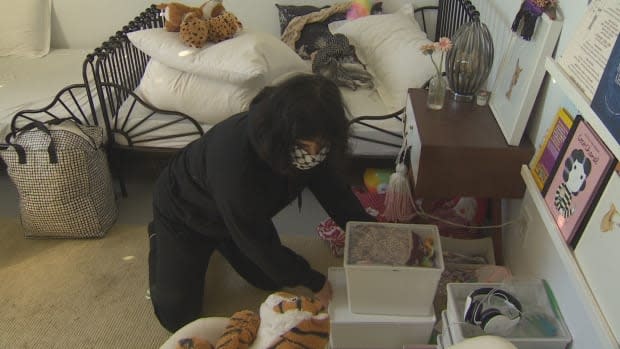 Building resident and single mother of two Tahsin Davdani packs up her daughters' room. She says residents need more help to face this "panicky" situation they're now in. 