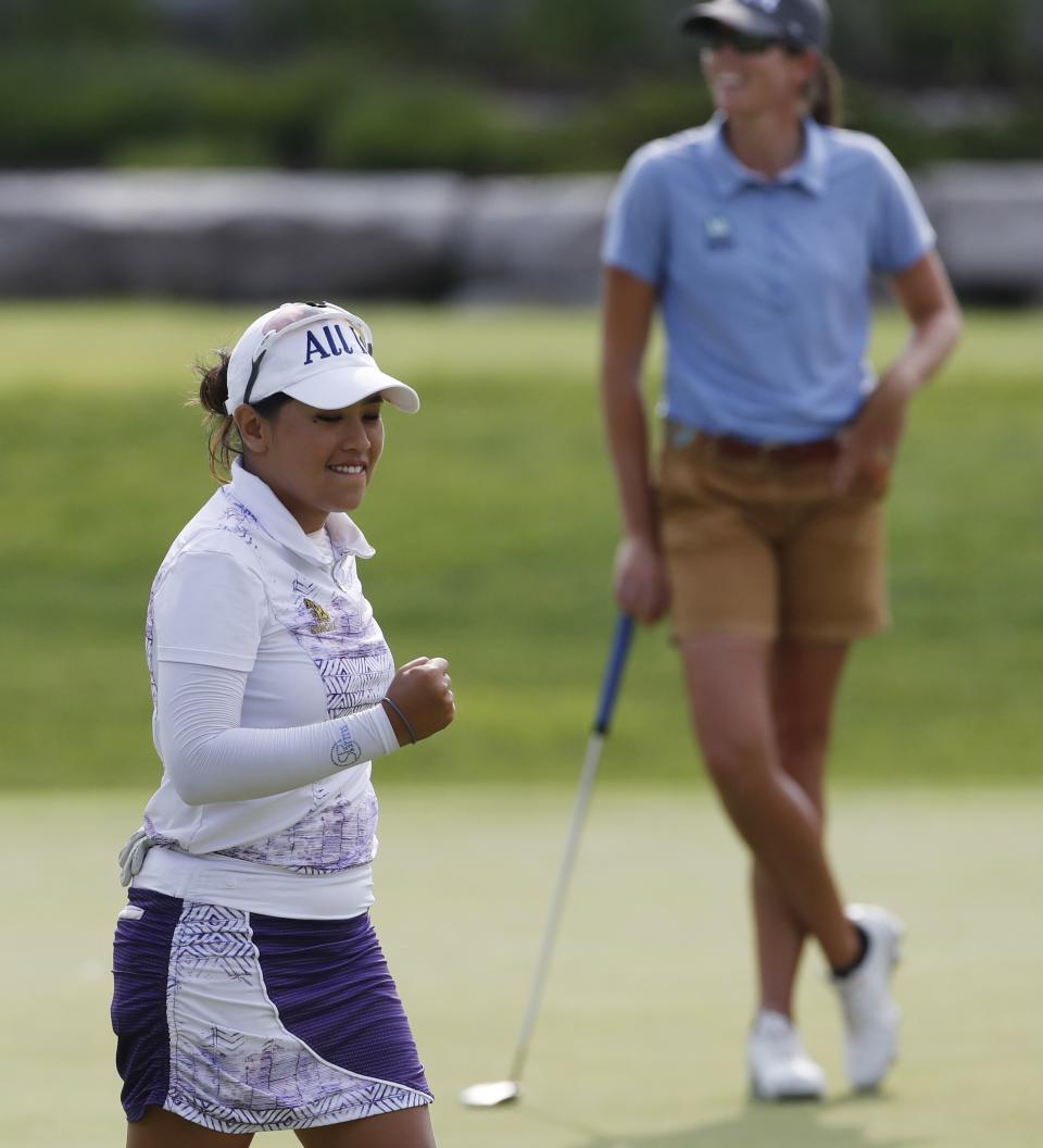 Jasmine Suwannapura, of Thailand, reacts after her birdie putt on the 18th green during the third round of the LPGA's Dow Great Lakes Bay Invitational golf tournament Friday, July 19, 2019, in Midland, Mich. (AP Photo/Carlos Osorio)