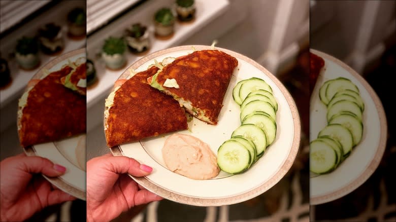 A dollop of Love Dip next to quesadilla and cucumbers