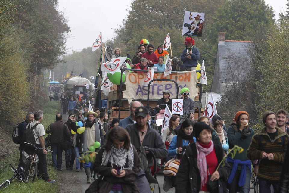 FILE - This Nov. 17, 2012 file photo shows demonstrators proceeding on a road near Notre Dame des Landes, western France, as part of a protest against a project to build an international airport, in Notre Dame des Landes, near Nantes. An unlikely alliance of anarchists and beret-wearing farmers is creating a headache for President Francois Hollande’s beleaguered government by mounting an escalating Occupy Wall Street-style battle that has delayed construction on the ambitious airport near the city of Nantes for months. (AP Photo/David Vincent, File)