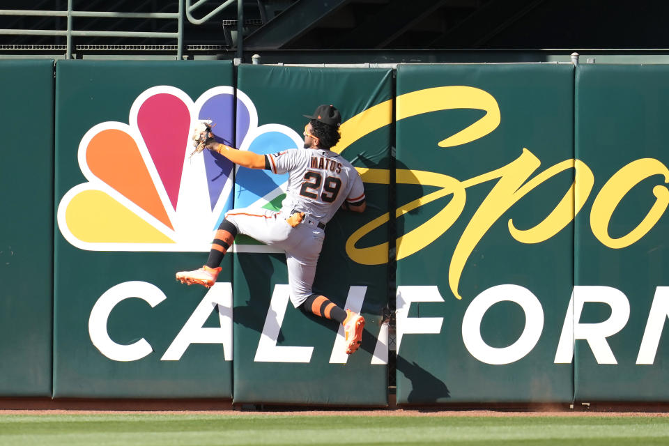 San Francisco Giants center fielder Luis Matos (29) hits the wall after catching a fly out by Oakland Athletics' Seth Brown during the fourth inning of a baseball game in Oakland, Calif., Saturday, Aug. 5, 2023. (AP Photo/Jeff Chiu)