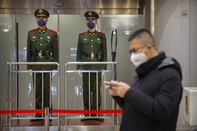 FILE - In this Thursday, Jan. 23, 2020, file photo, Chinese paramilitary police wear face masks as they stand guard at Beijing Capital International Airport in Beijing. British Airways and Asian budget carriers Lion Air and Seoul Air are suspending all flights to China as fears spread about the outbreak of a new virus that has killed more than 130 people. British Airways said Wednesday it is immediately suspending all flights to and from mainland China after the U.K. government warned against unnecessary travel to the country. (AP Photo/Mark Schiefelbein, File)