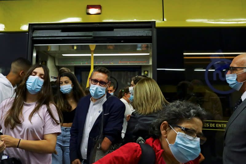 Rui Brito, a worker with a disability, exits a subway car after work in Porto