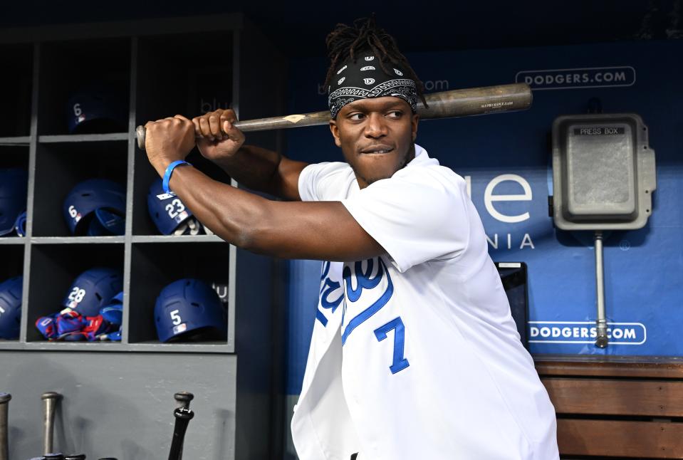 Mar 31, 2023; Los Angeles, California, USA; British YouTuber KSI and cruiserweight professional boxer swings a bat in the dugout prior to the game between the Los Angeles Dodgers and the Arizona Diamondbacks at Dodger Stadium. Mandatory Credit: Jayne Kamin-Oncea-USA TODAY Sports