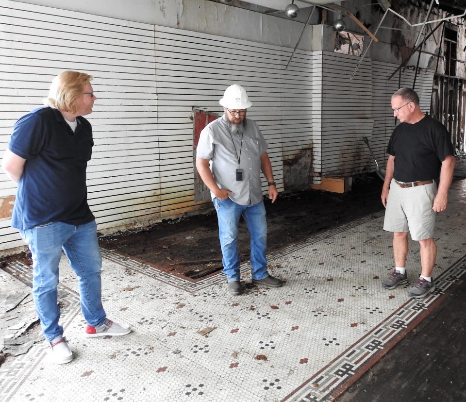 Lanny Spaulding and Tom Barcroft of Our Town Coshocton review floor issues with Doug Hooper of Midstate Contractors of Marion, center. OTC recently received $45,000 from the capital budget for continued renovations of the historic building.