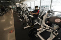 FILE - In this Tuesday, Sept. 15, 2020 file photo Wesley Thomas works out at Fitness SF Transbay during the coronavirus outbreak in San Francisco. A steady drop in coronavirus cases across California cleared the way Tuesday, Sept. 22, 2020, for the wider reopening of businesses in nine counties, including much of the Bay Area, the state said. (AP Photo/Jeff Chiu,File)