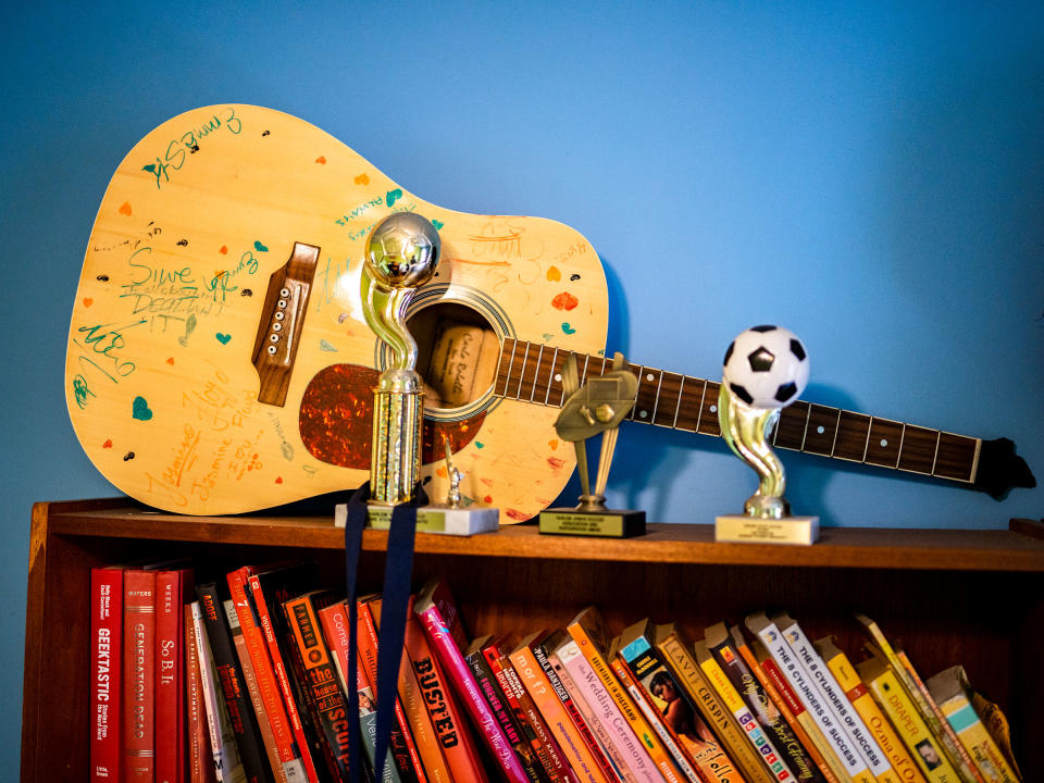 A guitar amongst trophies and books on a shelf in Siwe's bedroom. “She was brilliant," her mother said. "She was beautiful. She was a writer. She was a guitar player. She was a dancer."Elias Williams for TIME