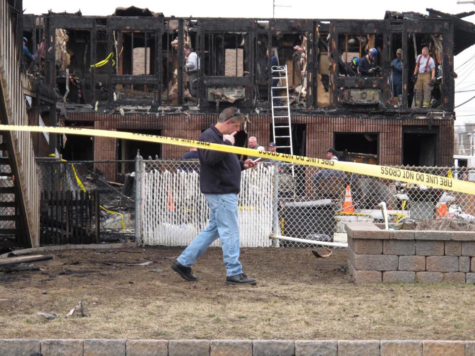 Investigators look through the rubble of a motel in Point Pleasant Beach N.J. on Saturday, March 22, 2014. Autopsies were being conducted Saturday on the four people who died in a fire at a Jersey shore motel that housed some victims who lost their homes when Superstorm Sandy hit. Al Della Fave, a spokesman for the Ocean County Prosecutor's Office, said the medical examiner's office is trying to identify the victims and determine how they died in the blaze at the Mariner's Cove Motor Inn in Point Pleasant Beach early Friday morning. An intense investigation into the cause of the blaze began Friday afternoon after the last of the four bodies was removed. Eight people were injured in the fire. The probe into the cause is expected to take several days. (AP Photo/Wayne Parry)