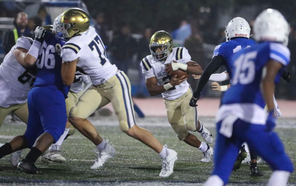 Salesianum's Brian Alleyne takes a handoff as he gets blocks from teammates including Luke Guzevich (77) in the fourth quarter of the Senators' 27-16 win in Dover, Friday, Sept. 29, 2023.