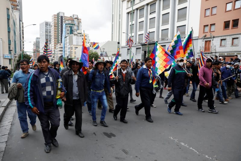 Supporters of Bolivia's ousted President Evo Morales hold Wiphala flags as they take part in a protest, in La Paz