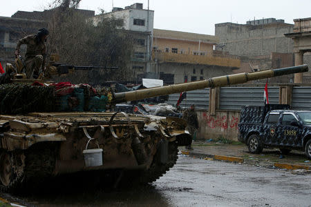 A member of Iraqi rapid response forces is seen on a tank during clashes with Islamic State militants in Mosul, Iraq March 13, 2017. REUTERS/Azad Lashkari