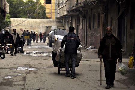 Residents walk in the rebel held town of Yalda, south Damascus April 11, 2015. REUTERS/Moayad Zaghmout