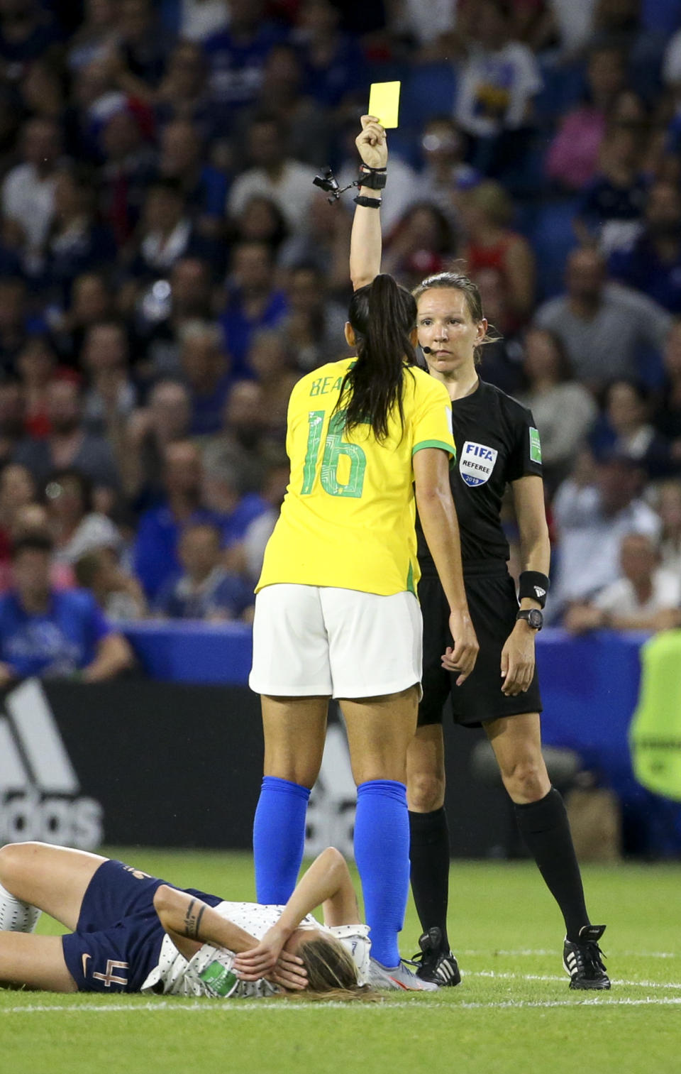 Beatriz Zaneratto Joao of Brazil receives a yellow card from referee Marie-Soleil Beaudoin of Canada during the 2019 FIFA Women's World Cup France Round Of 16 match between France and Brazil at Stade Oceane on June 23, 2019 in Le Havre, France. (Photo by Jean Catuffe/Getty Images)