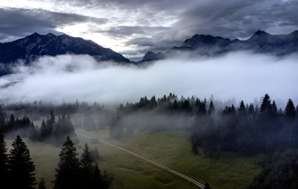 Fog lies over the valley where Elmau castle is located, Klais, Germany, Saturday, June 25, 2022. The G7 summit will start on Sunday. (AP Photo/Michael Probst)