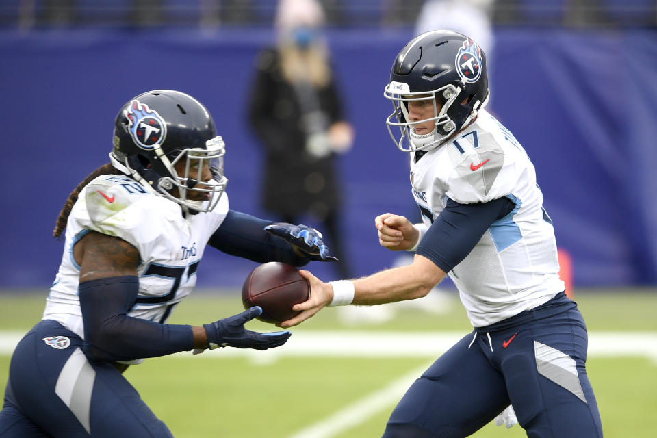 Tennessee Titans quarterback Ryan Tannehill, right, hands off to running back Derrick Henry during the first half of an NFL football game against the Baltimore Ravens, Sunday, Nov. 22, 2020, in Baltimore. (AP Photo/Nick Wass)