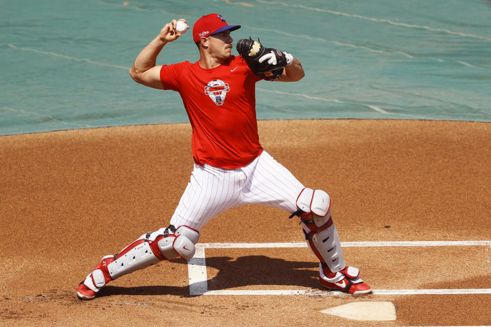 FILE - In this July 6, 2020, file photo, Philadelphia Phillies' J.T. Realmuto throws to second base during baseball practice at Citizens Bank Park in Philadelphia. (AP Photo/Matt Slocum, File)