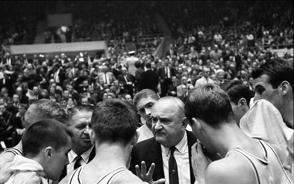 Kentucky basketball coach Adolph Rupp speaks to his team during a game against Notre Dame at Louisville's Freedom Hall on December 29, 1964.