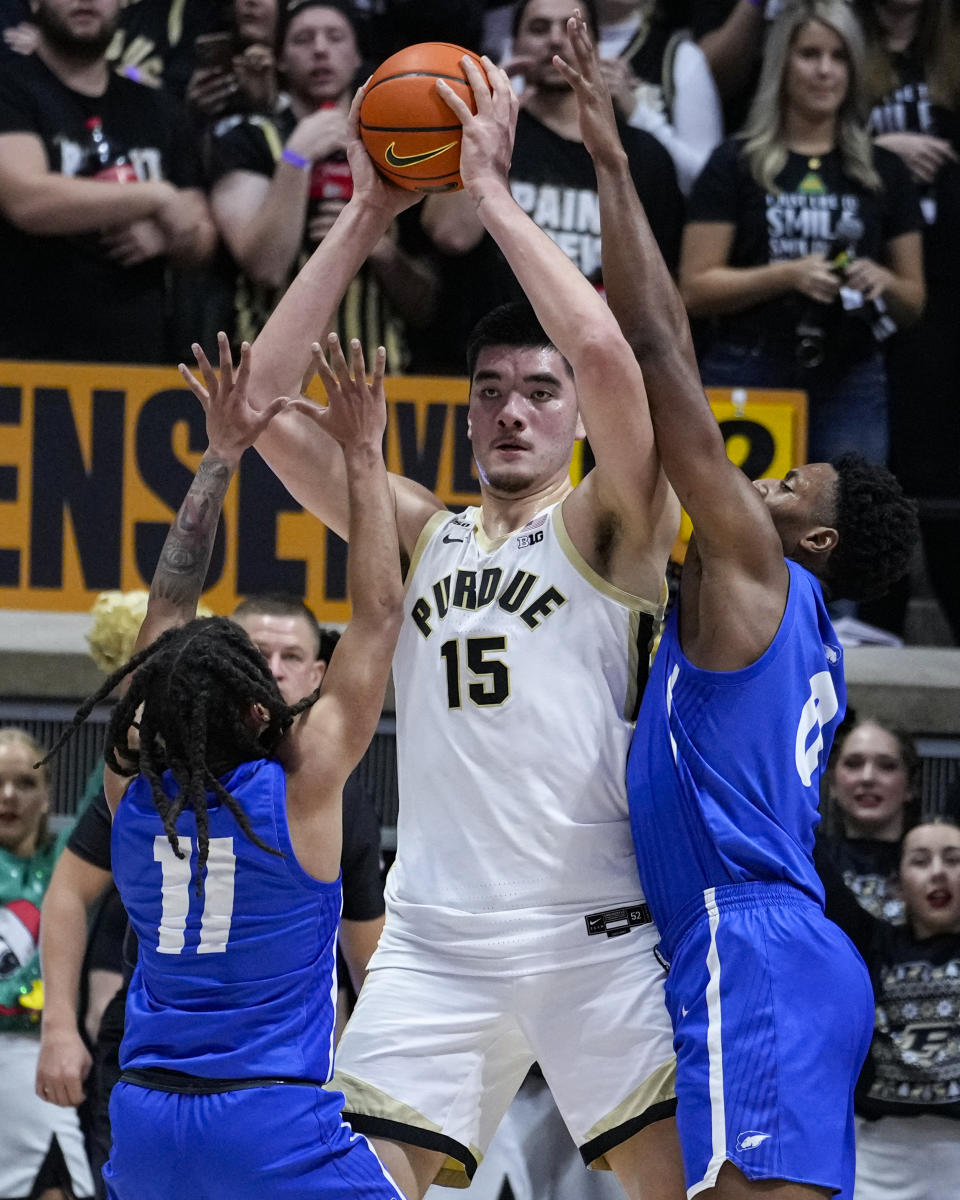 Hofstra guard Jaquan Carlos (11) and forward Warren Williams (0) try to trap Purdue center Zach Edey (15) during the first half of an NCAA college basketball game in West Lafayette, Ind., Wednesday, Dec. 7, 2022. (AP Photo/Michael Conroy)