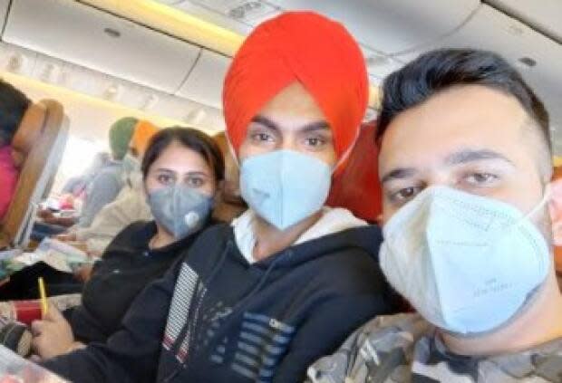 Sandeep Kathuria is pictured here on the far right on the flight from India to Canada.