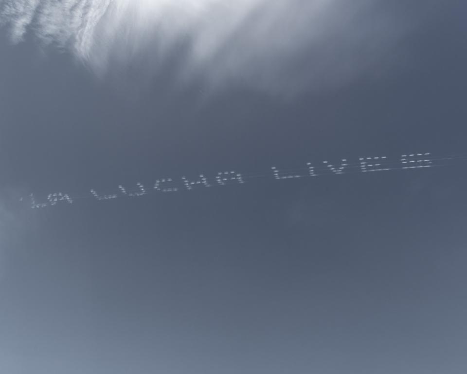 A skytyped message over the Central Texas Detention Facility in San Antonio reads "La lucha lives."