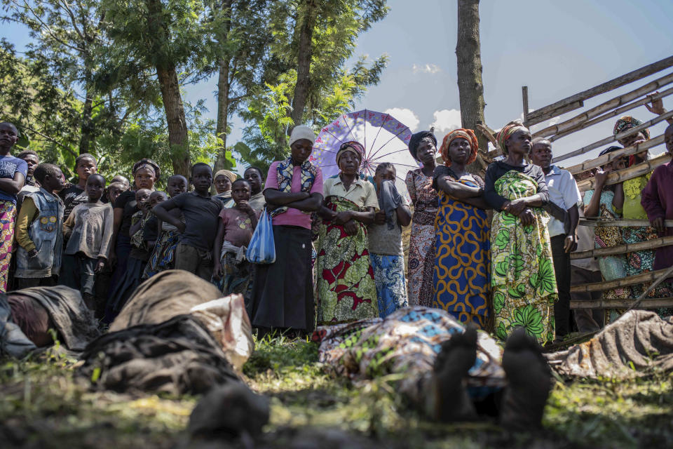 Relatives gather to identify bodies in the village of Nyamukubi, South Kivu province, Congo, Saturday, May 6, 2023. The death toll from flash floods and landslides in eastern Congo has risen to over 150, with some 100 people still missing, according to a provisional assessment given by the governor and authorities in the country's South Kivu province. (AP Photo/Moses Sawasawa)