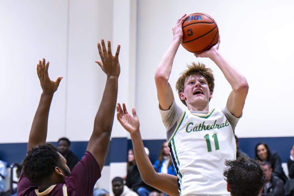 Indianapolis Cathedral High School junior Brady Koehler (11) shoots over Brebeuf Jesuit Preparatory High School defenders during the second half of an IHSAA basketball game, Friday, Dec. 1, 2023, at Cathedral. Cathedral won, 79-63.