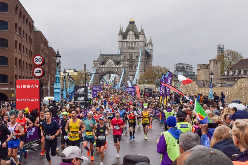 Thousands of runners pass across Tower Bridge during London Marathon