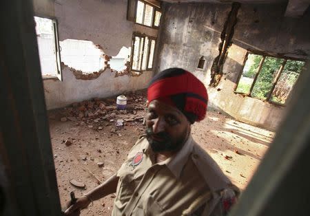 An Indian policeman stands inside a damaged police station after a gunfight in Dinanagar town in Gurdaspur district of Punjab, India, July 27, 2015. REUTERS/Munish Sharma