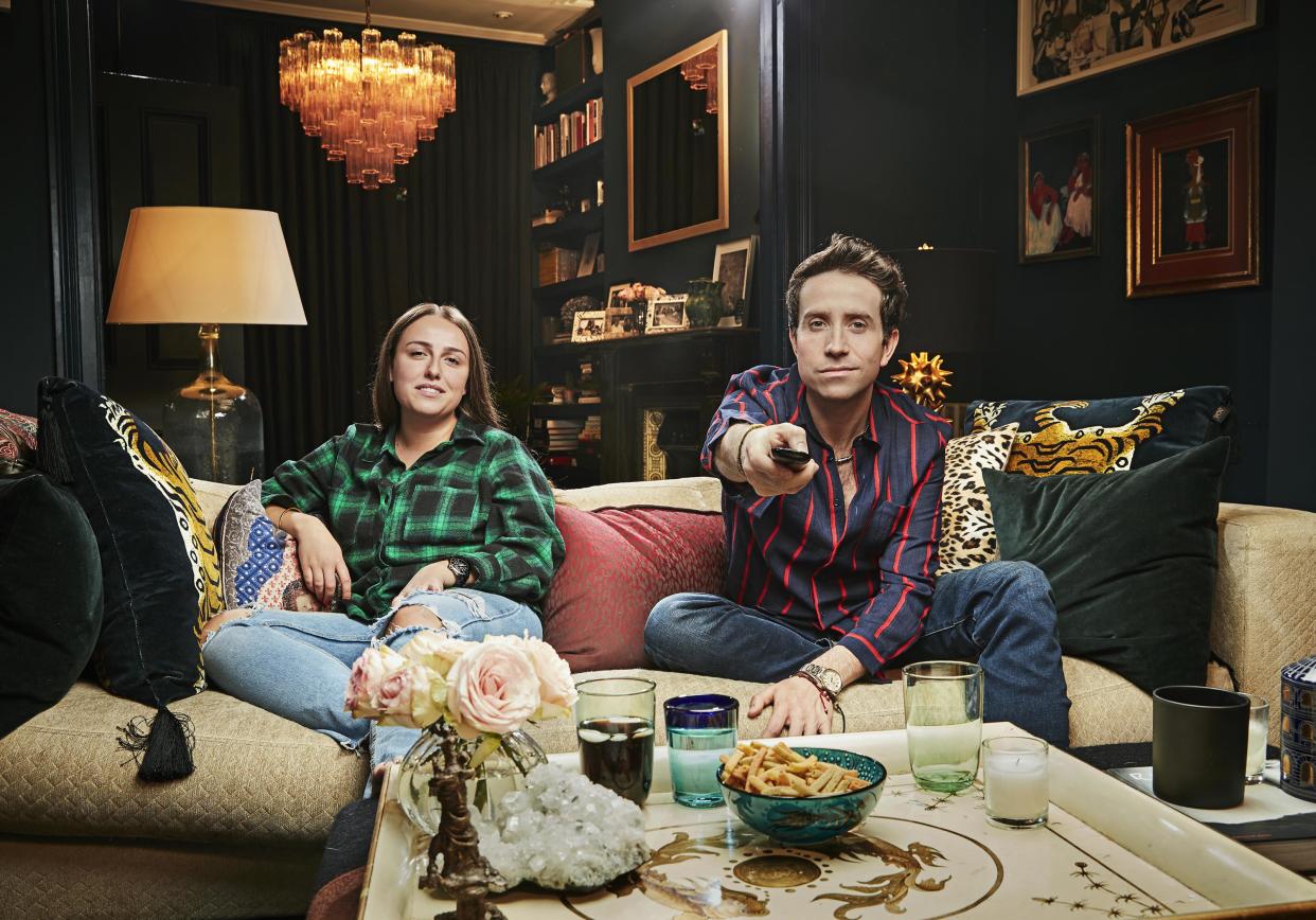  Nick Grimshaw and his niece Liv sitting on the sofa. Nick is pointing the TV remote at the camera 