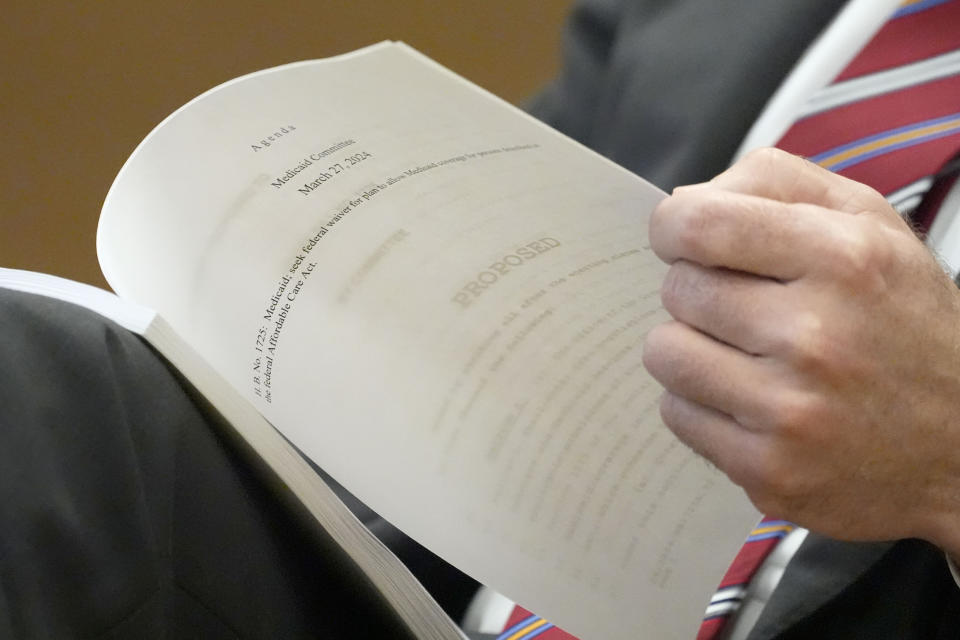 A Mississippi State Senate Medicaid Committee member reviews a proposed Medicaid expansion bill during the committee's meeting, at the state Capitol in Jackson, Miss., Wednesday, March 27, 2024. (AP Photo/Rogelio V. Solis)