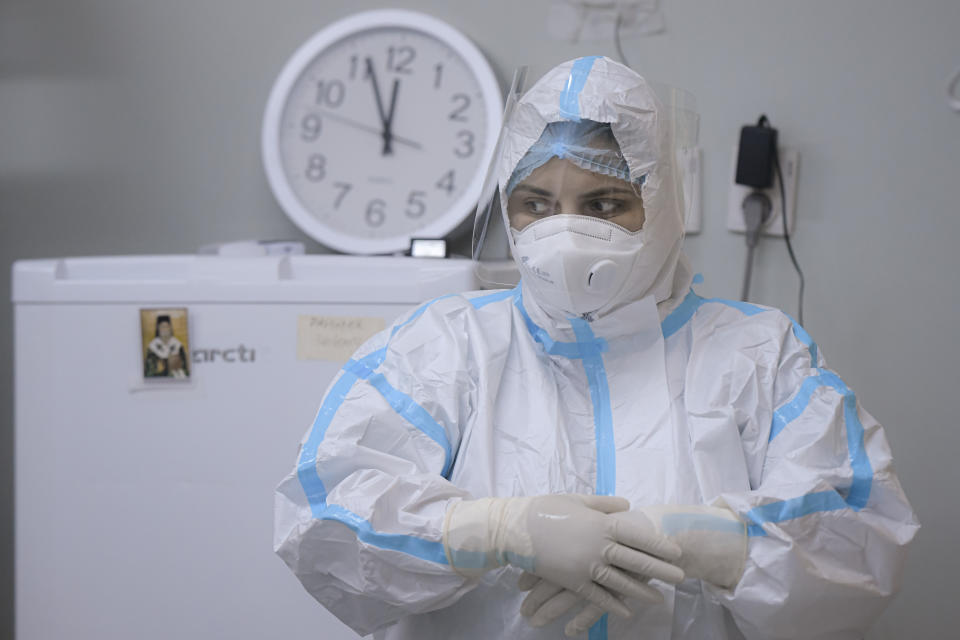 A member of the medical staff adjusts her gloves at the COVID-19 ICU unit of the Marius Nasta National Pneumology Institute in Bucharest, Romania, Thursday, Sept. 23, 2021. Daily new coronavirus infections in Romania, a country of 19 million, have grown exponentially over the last month, while vaccine uptake has declined to worrying lows. Government data shows that 91.5% of COVID-19 deaths in Romania between Sept. 18-23 were people who had not been vaccinated. (AP Photo/Andreea Alexandru)