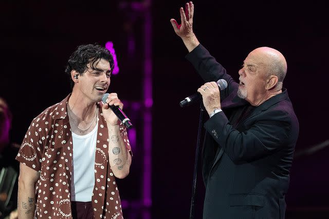 <p>Dave Hogan/Hogan Media/Shutterstock</p> Joe Jonas and Billy Joel perform at BST Hyde Park in London on July 7, 2023