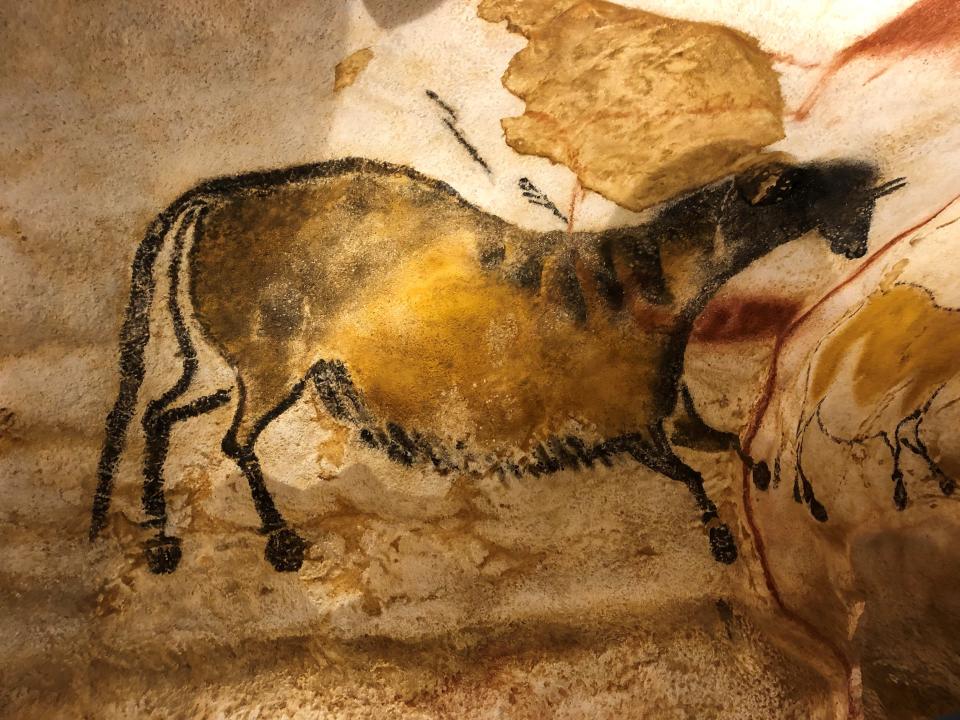 A striped horse gallops on the wall at Lascaux II in rural France, where paintings were painstakingly copied to preserve the original images.