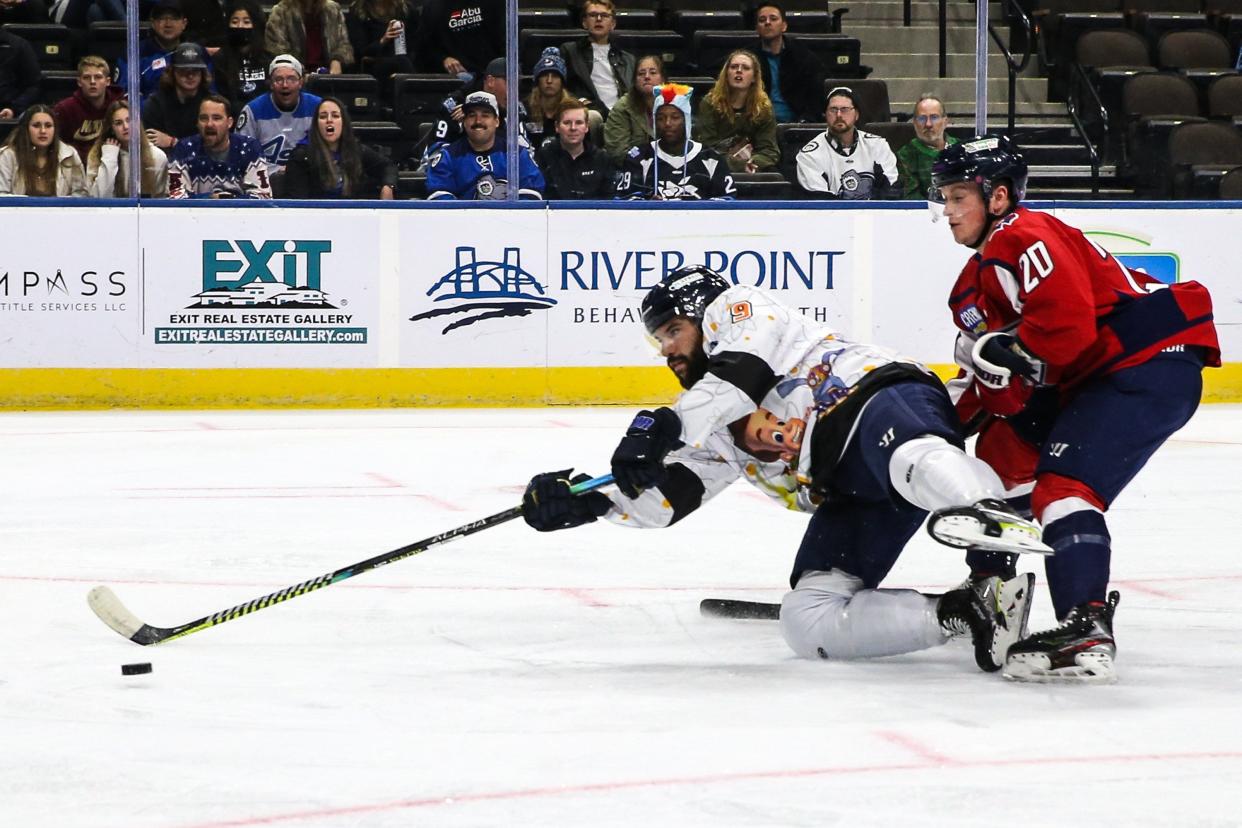 Jacksonville Icemen forward Luke Lynch (9) scores the games first goal in front of South Carolina Stingrays defenseman Skyler Smutek (20), right, during an ECHL hockey game at Veterans Memorial Arena in Jacksonville, Fla., Friday, Jan. 21, 2022.  [Gary Lloyd McCullough/For the Jacksonville Icemen]