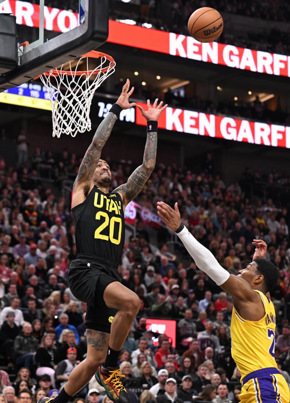 Utah Jazz forward John Collins (20) goes up for and catches a pass for a dunk over Los Angeles Lakers forward Rui Hachimura (28) as the Utah Jazz and the Los Angeles Lakers play at the Delta Center in Salt Lake City on Wednesday, Feb. 14, 2024. | Scott G Winterton, Deseret News