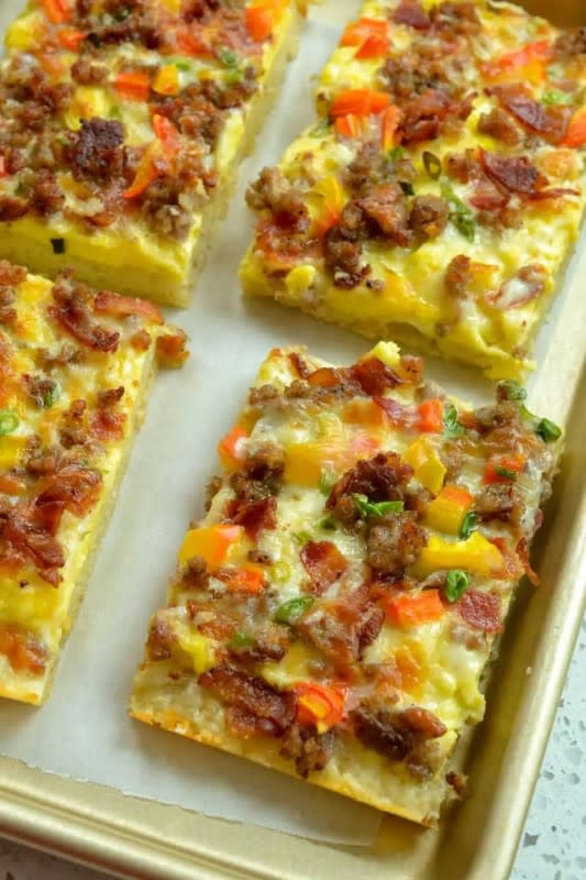 <p>Small Town Woman</p><p>This scrumptious breakfast pizza is topped with crispy bacon, browned pork sausage, sweet red bell pepper, scallions, scrambled eggs, and oodles of cheddar and Pepper Jack Cheese for the ultimate breakfast flavors in a crispy pizza crust.</p><p><strong>Get the recipe: <a href="https://www.smalltownwoman.com/breakfast-pizza/" rel="nofollow noopener" target="_blank" data-ylk="slk:Loaded Breakfast Pizza;elm:context_link;itc:0;sec:content-canvas" class="link rapid-noclick-resp">Loaded Breakfast Pizza</a></strong></p>