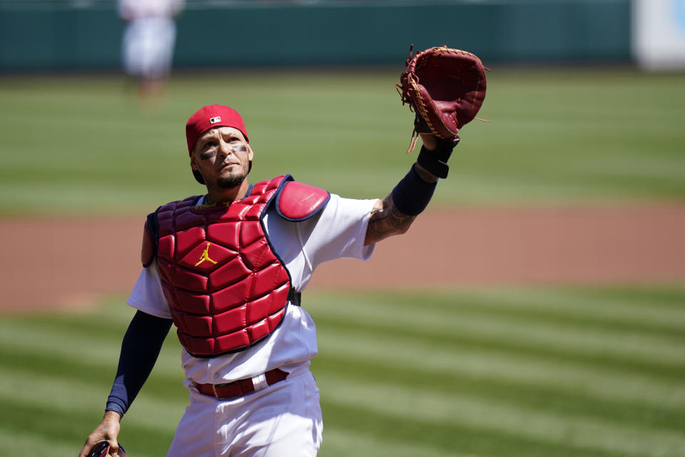 St. Louis Cardinals catcher Yadier Molina waves to cheering fans after starting a baseball game against the Washington Nationals and becoming the first catcher in major league history to catch 2000 games with one team Wednesday, April 14, 2021, in St. Louis. (AP Photo/Jeff Roberson)