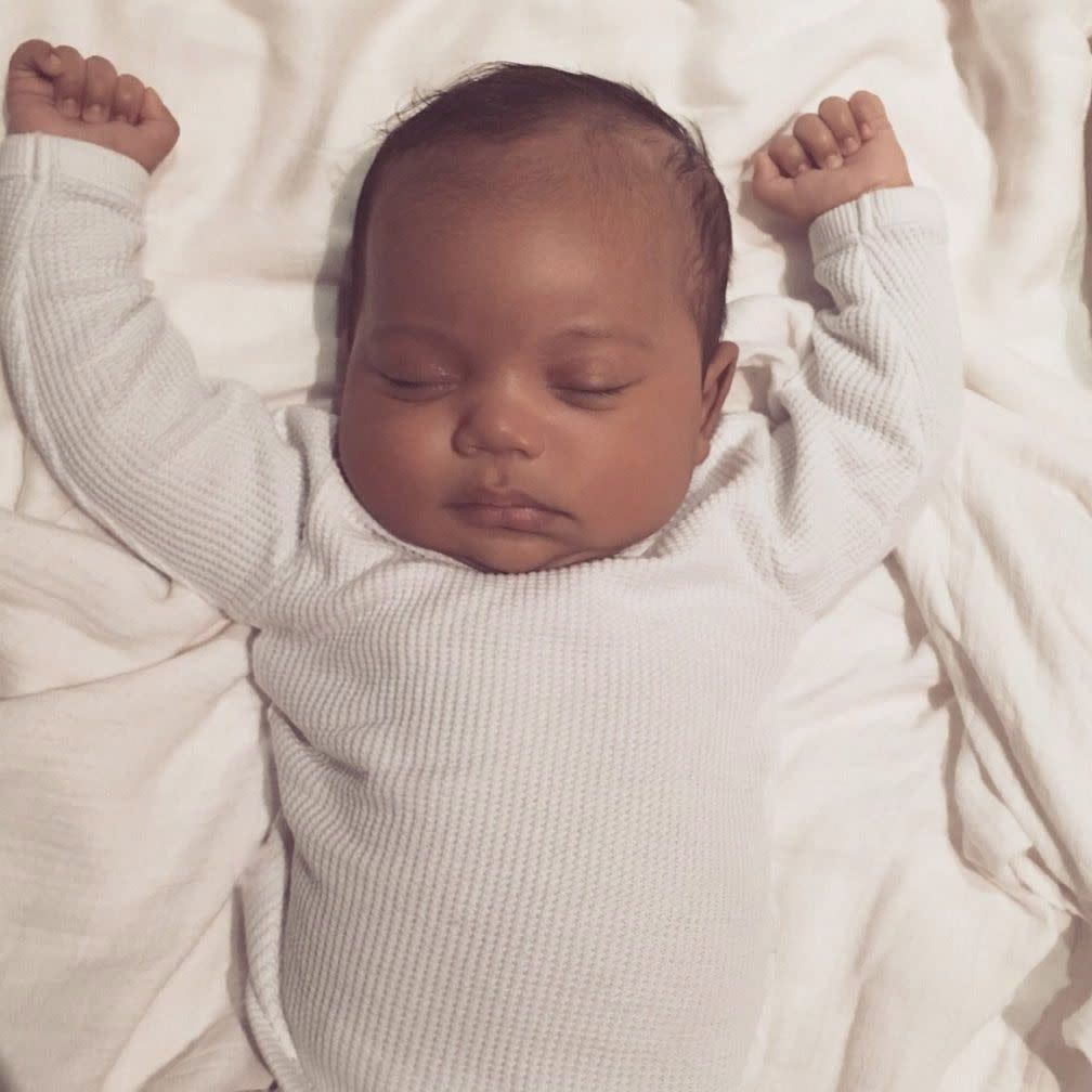 World, meet Kim and Kanye's son: Saint West! Kim Kardashian shared the first photo of their adorable 3-month-old baby, dressed in a white thermal onesie as he sleeps with his hands in the air. "Today is my dad's birthday. I know there's nothing more in the world he would have wanted than to meet his grandchildren. So I wanted to share this pic of Saint with you all," Kim captioned the snap on Feb. 23, 2016.