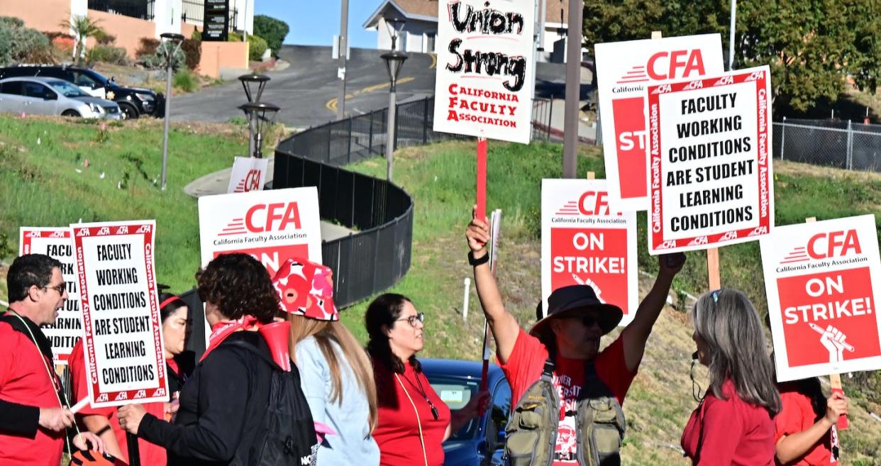 Members of the faculty union of the California State University system walk a picket line in December 2023. <a href="https://www.gettyimages.com/detail/news-photo/members-of-the-faculty-union-of-the-california-state-news-photo/1827960132?adppopup=true" rel="nofollow noopener" target="_blank" data-ylk="slk:Frederic J. Brown/AFP via Getty Images;elm:context_link;itc:0;sec:content-canvas" class="link ">Frederic J. Brown/AFP via Getty Images</a>