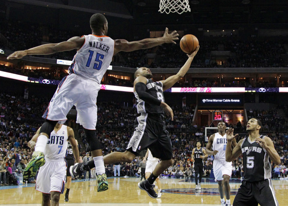 San Antonio Spurs' Patty Mills (8) drives past Charlotte Bobcats' Kemba Walker (15) during the second half of an NBA basketball game in Charlotte, N.C., Saturday, Feb. 8, 2014. The Spurs won 104-100. (AP Photo/Chuck Burton)