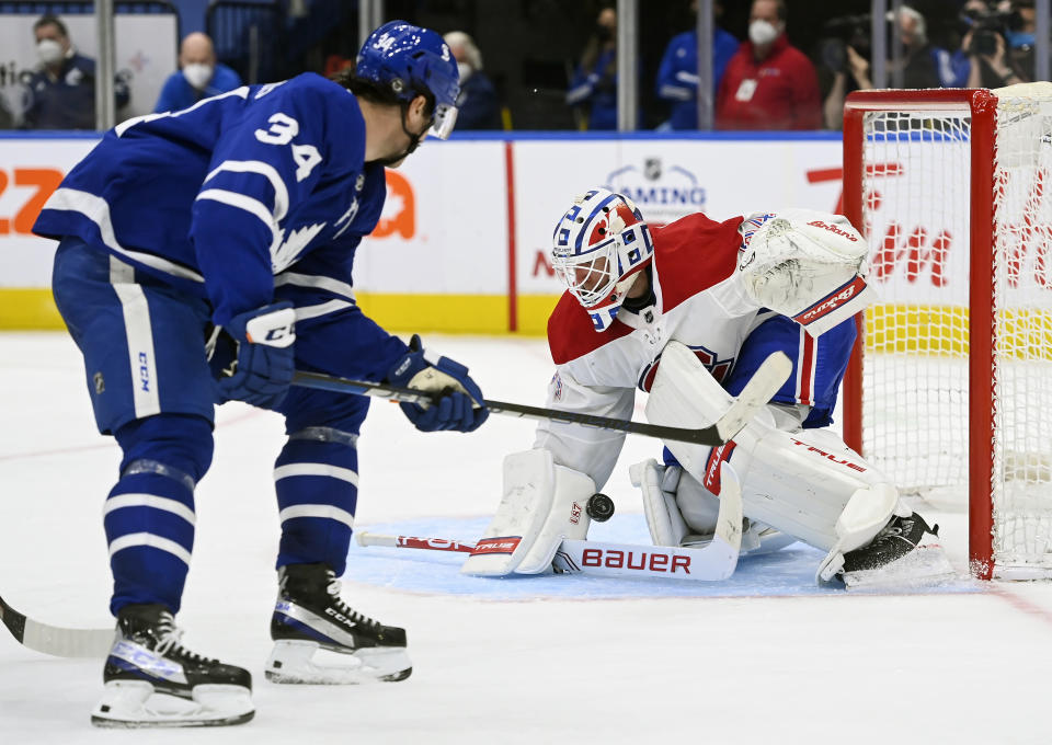 Montreal Canadiens goaltender Jake Allen (34) makes a save against Toronto Maple Leafs forward Auston Matthews (34) during the third period of an NHL hockey game Wednesday, April 7, 2021, in Toronto. (Nathan Denette/The Canadian Press via AP)
