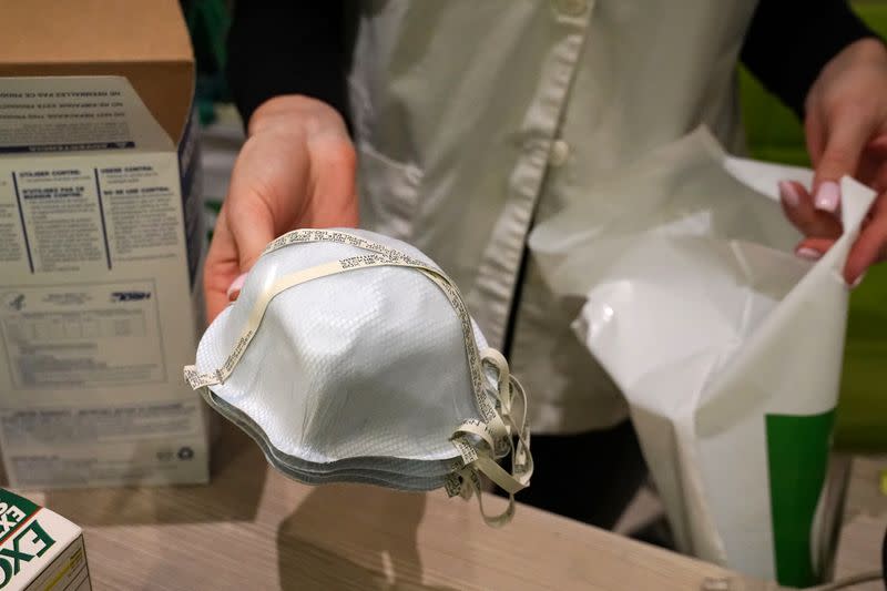 A pharmacy worker sells N95 face masks in advance of the potential coronavirus outbreak in the Manhattan borough of New York City