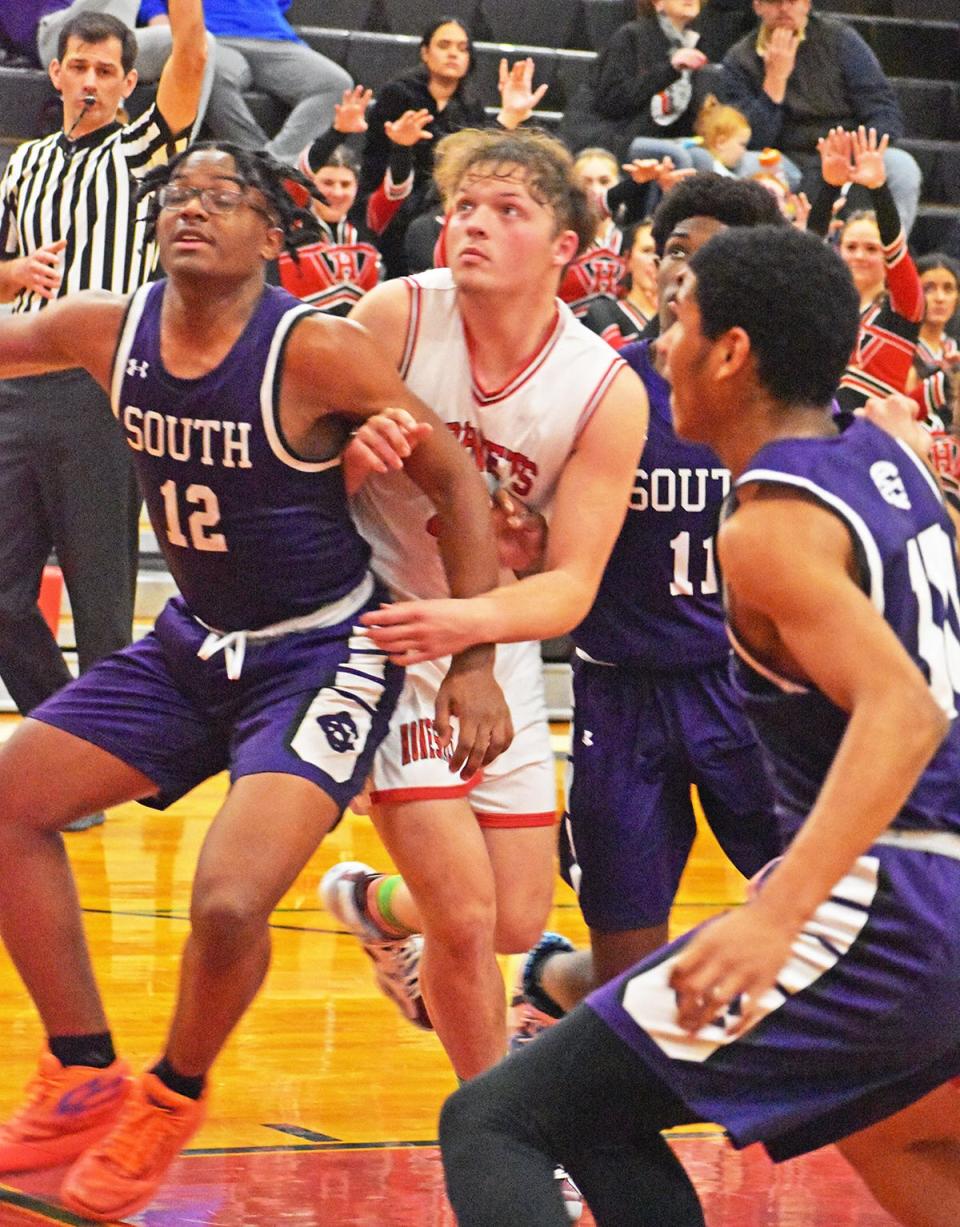 East Stroudsburg South players working hard to box out against Honesdale. Pictured are Xavier Carnegie (12), Daunte Williams (11) and Fitzroy Walters Jr (10).